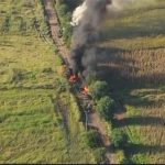 Vehicles belonging to the Jalisco New Generation Cartel burn on a road in the Tierra Caliente region.