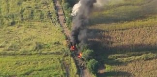 Vehicles belonging to the Jalisco New Generation Cartel burn on a road in the Tierra Caliente region.