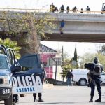 A body hangs from an overpass in Cuauhtémoc on Thursday.