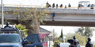 A body hangs from an overpass in Cuauhtémoc on Thursday.