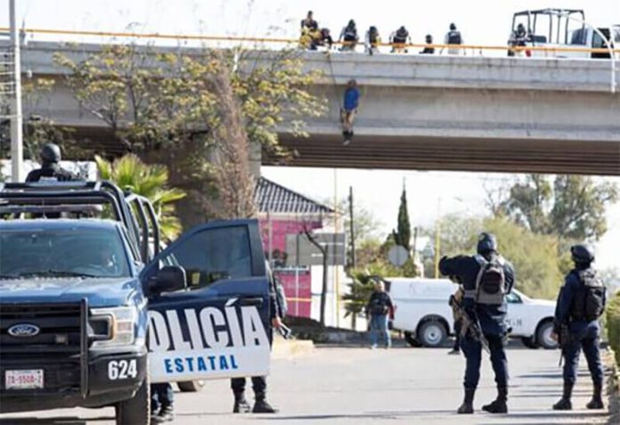 A body hangs from an overpass in Cuauhtémoc on Thursday.