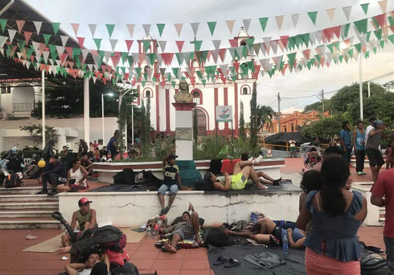 Migrants rest outside the church in Pijijiapan.