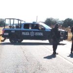 A police roadblock on a highway near a location where bodies had been found.