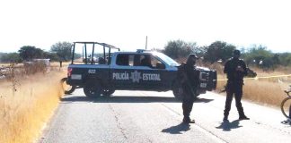 A police roadblock on a highway near a location where bodies had been found.