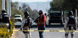 Security forces on patrol at Thursday's crime scene.