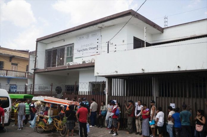 Long lines of migrants wait outside the Mexican refugee agency (COMAR) office in Tapachula, Chiapas.