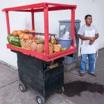 Even fruit vendors in the street are targets for extortion.