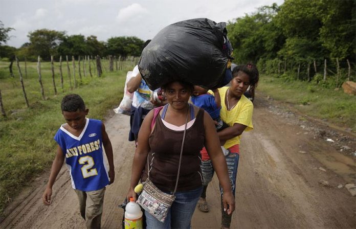 A group of Honduran migrants on the border of Honduras and El Salvador heading north in 2018.