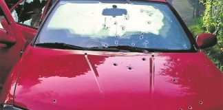 The vehicle found at the crime scene was riddled with bullet holes.