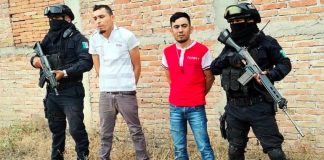 Police with their two suspects on Tuesday.