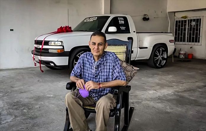 Juan Manuel Vidales with the Chevrolet pickup he raffled to raise money for his cancer treatment.