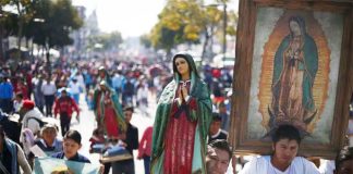 Pilgrims carrying images of the Virgin of Guadalupe.