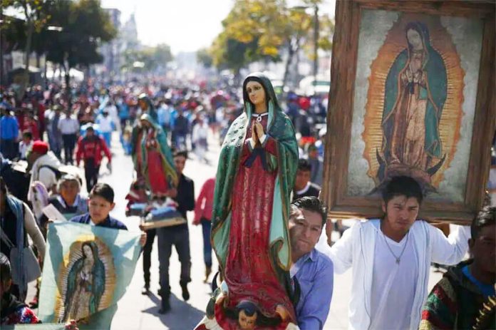 Pilgrims carrying images of the Virgin of Guadalupe.
