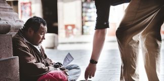 A Zacatecas man accepts alms from a stranger.