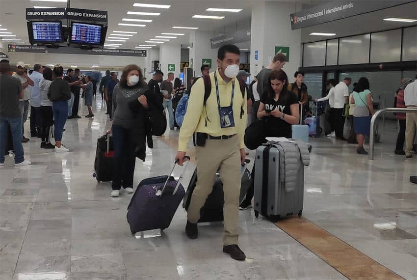 Travelers with face masks at the the Mexico City International Airport.