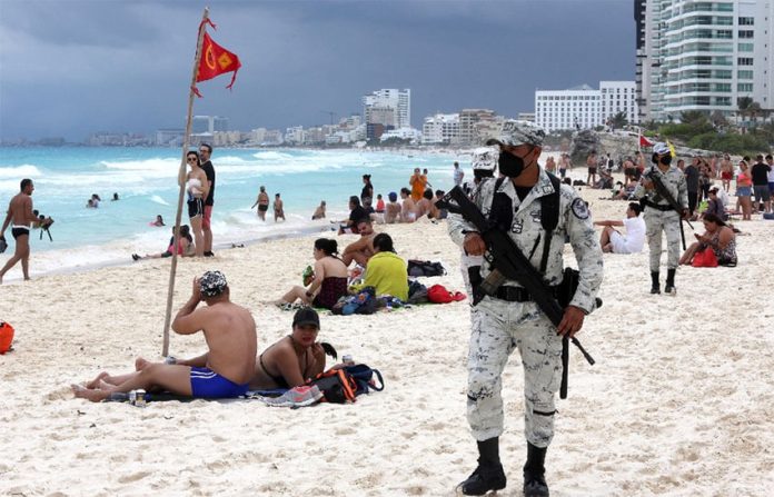 National Guard troops patrol a beach in Cancún, Quintana Roo.
