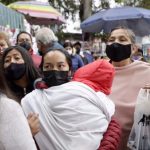 Patients and families with children wait outside Mexico City's La Raza IMSS public hospital, one of the facilities where all COVID beds are full.