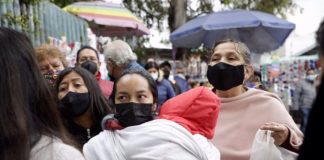 Patients and families with children wait outside Mexico City's La Raza IMSS public hospital, one of the facilities where all COVID beds are full.