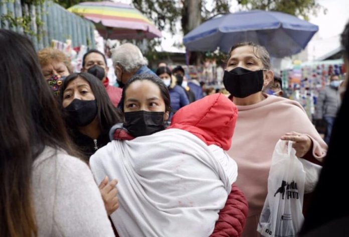 Patients and families with children wait outside Mexico City's La Raza IMSS public hospital, one of the facilities where all COVID beds are full.