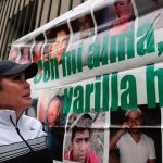 Margarita López, the founder of Buscando Cuerpos, in front of a banner commemorating disappeared people.