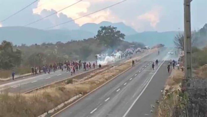Police fire tear gas at protesting students.