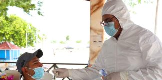A healthcare worker conducts a rapid test.