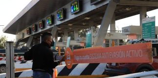 A man raises the boom at a toll plaza.