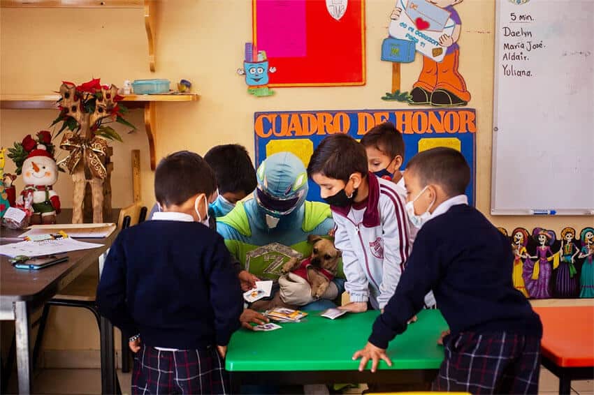 Children crowd around Zadrigman during a classroom visit.