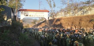 Soldiers stand at the entrance to Aguililla, in a photo shared by the National Defense Ministry on Wednesday.