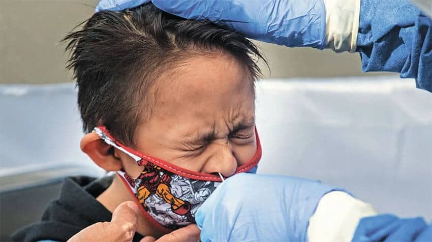 A child gets tested for COVID-19.
