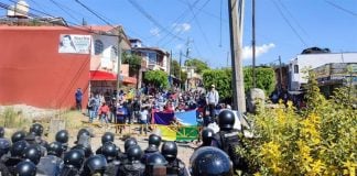 Teachers union members face off with police in Caltzontzin on Tuesday.