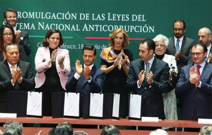 President Peña Nieto and other officials celebrate a new anti-corruption system in 2016.