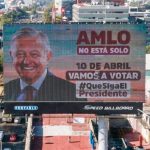 A billboard declares, 'AMLO is not alone,'