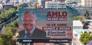 A billboard declares, 'AMLO is not alone,'