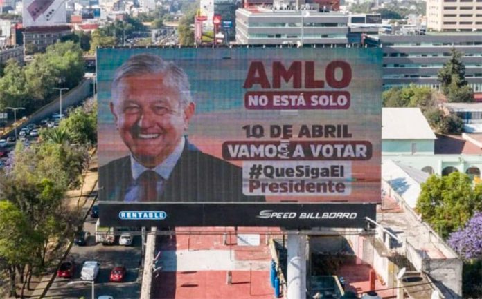 A billboard declares, 'AMLO is not alone,'