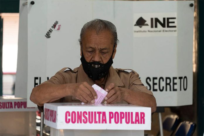 A man votes on a past referendum in Mexico City.