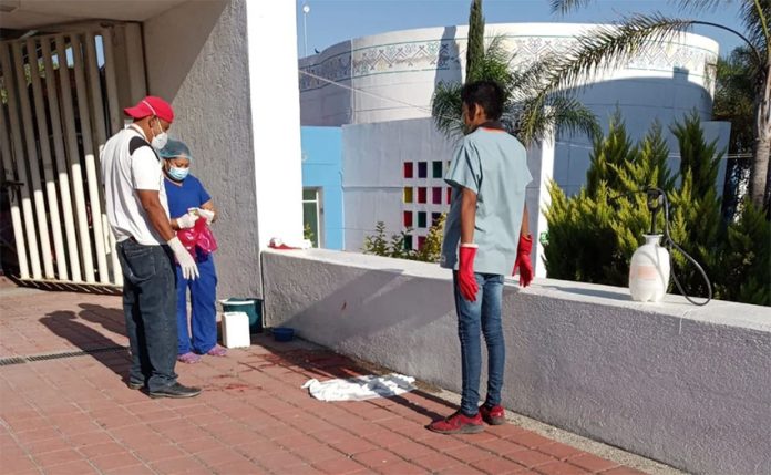 Workers clean up outside the Raymundo Abarca Alarcón General Hospital after the birth.