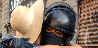 A police woman and a participant in Tuesday's march share a hug.