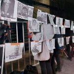 Protesters hang photos of murdered journalists at a January demonstration in Mexico City.