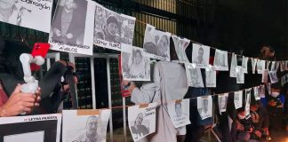 Protesters hang photos of murdered journalists at a January demonstration in Mexico City.