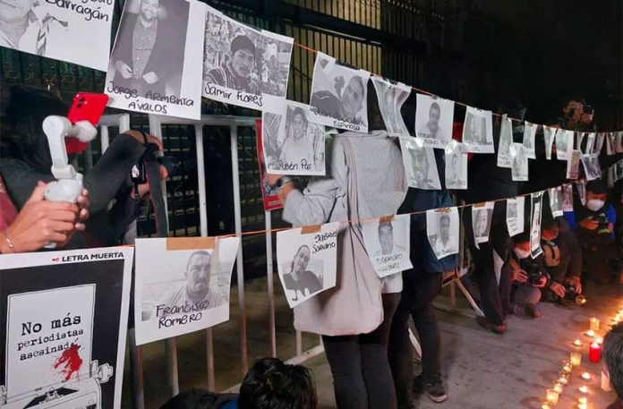 Protesters hang photos of murdered journalists at a January demonstration in Mexico City.