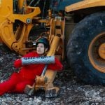 A train protester is tethered to a backhoe Monday in Quintana Roo.