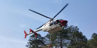 Helicopter spreading fire retardant in Nuevo Leon, Mexico