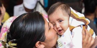 Mexican mom kissing baby