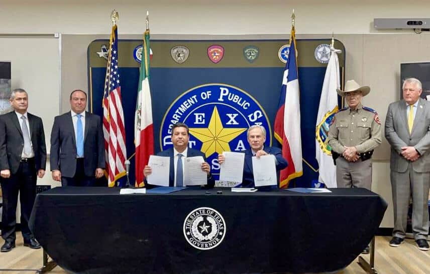 Tamaulipas Governor Francisco García Cabeza de Vaca and Texas Governor Greg Abbott hold up their new border security agreement at a Friday press conference. 
