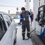 A gas station attendant at work in Tijuana.