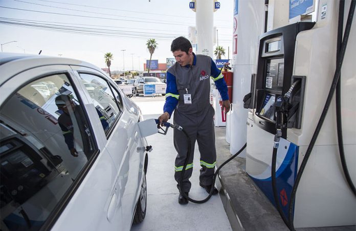 A gas station attendant at work in Tijuana.