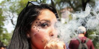 A woman smokes at a 2017 march in favor of cannabis legalization.