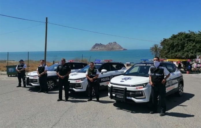 Municipal police pose with their new vehicles.