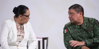 Security Minister Rosa Icela Rodríguez and Defense Minister Luis Cresencio Sandoval confer during the Wednesday morning press conference.